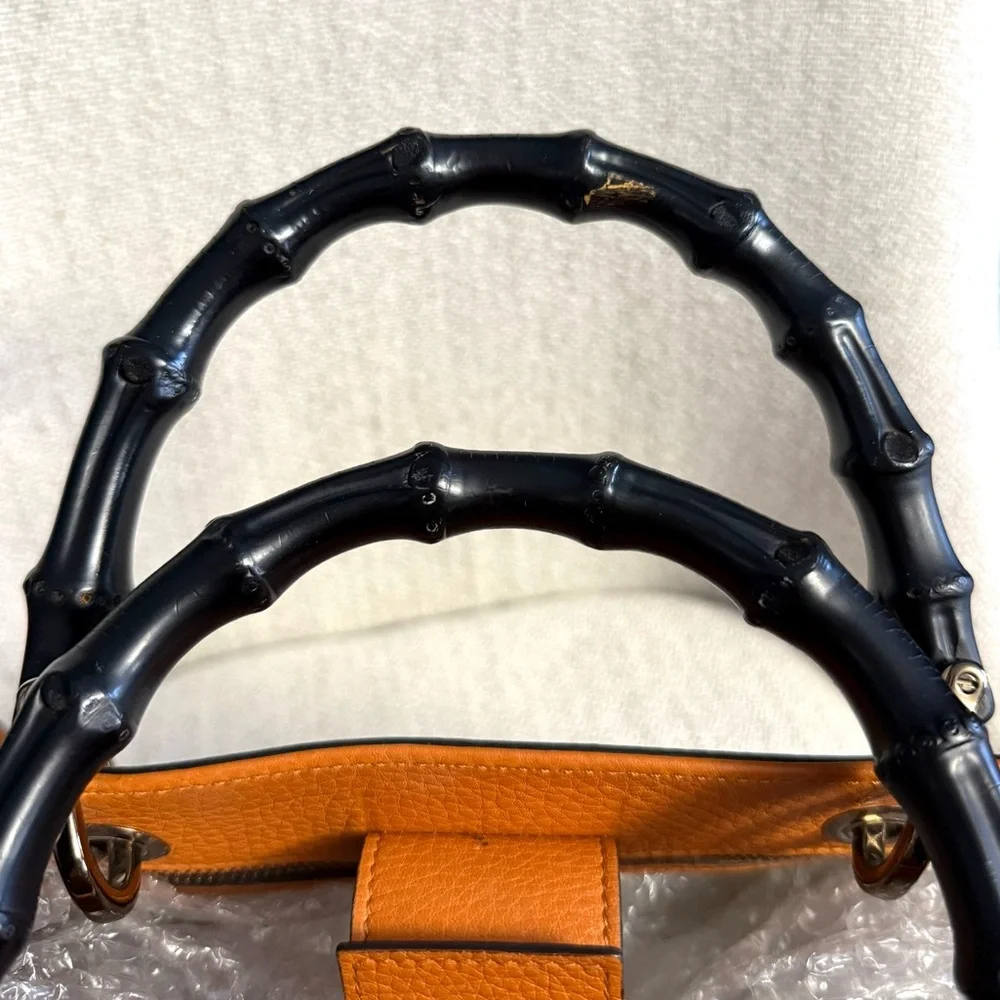 Gucci authentic satchel bag orange leather black bamboo handles with a strap